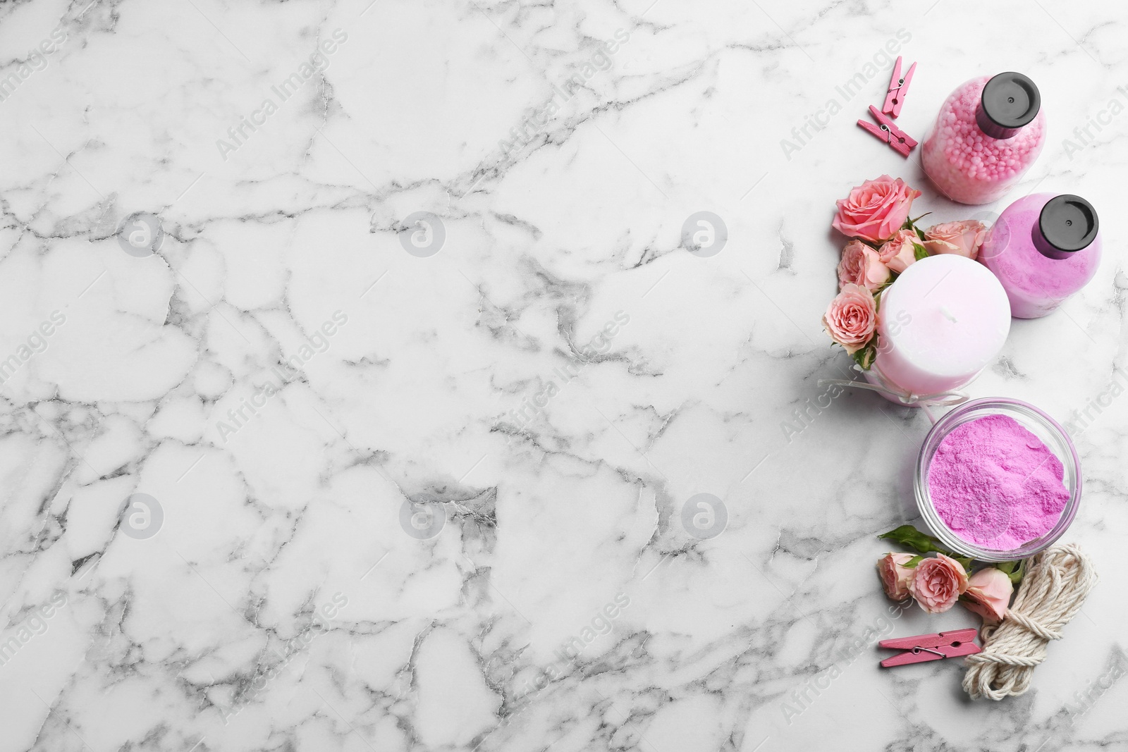 Photo of Flat lay composition with handmade rose candle on marble background. Space for text