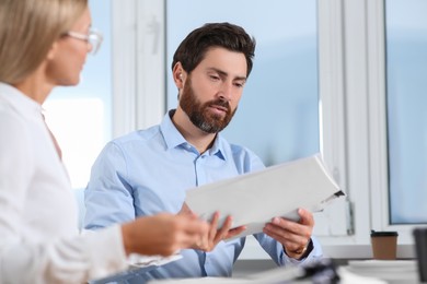 Photo of Businesspeople working with documents in modern office