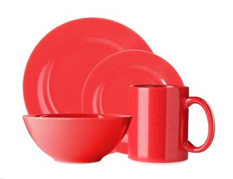 Set of beautiful red dinnerware on white background