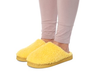 Photo of Woman in yellow soft slippers on white background, closeup