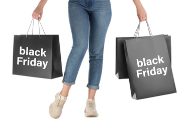 Photo of Woman with shopping bags on white background, closeup. Black Friday Sale