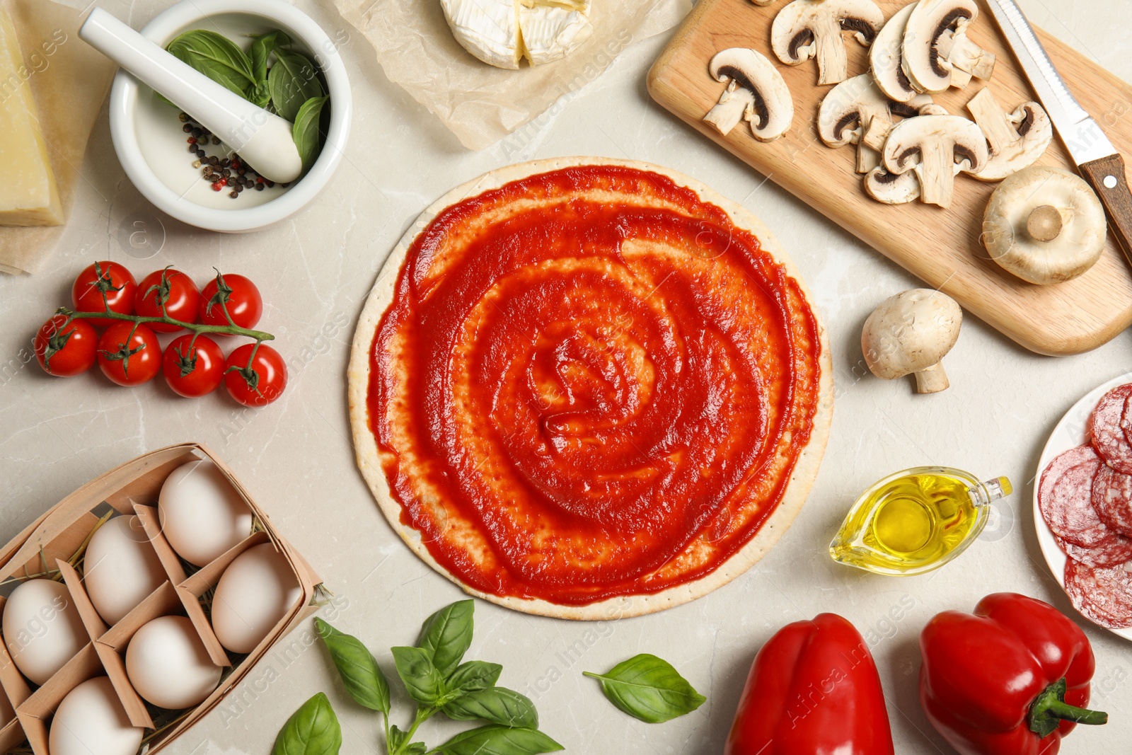 Photo of Flat lay composition with pizza crust and ingredients on marble table