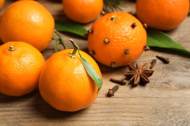 Photo of Fresh tangerines on wooden table, closeup. Christmas atmosphere