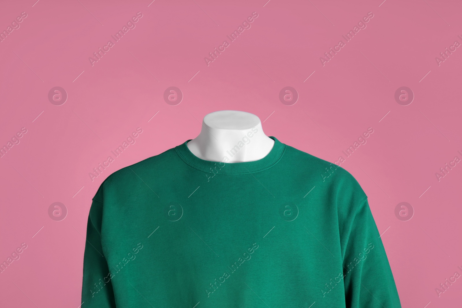 Photo of Male mannequin dressed in stylish green sweatshirt on pink background