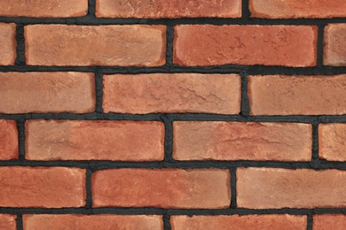 Photo of Decorative bricks on wall as background, closeup. Tiles installation process