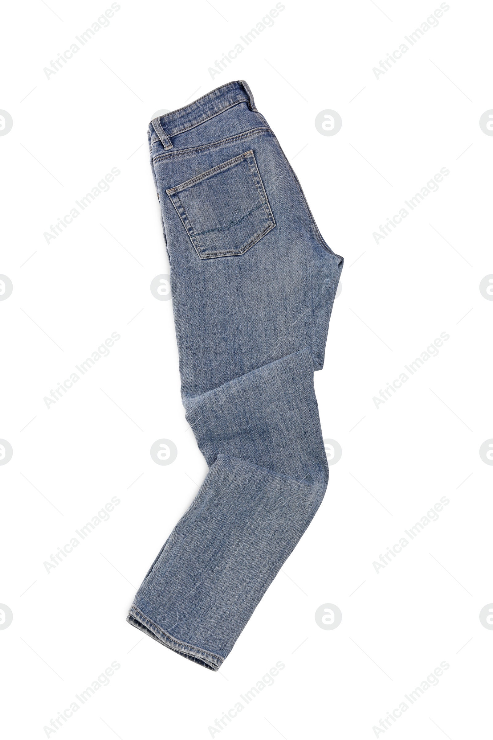 Photo of Stylish light blue jeans isolated on white, top view