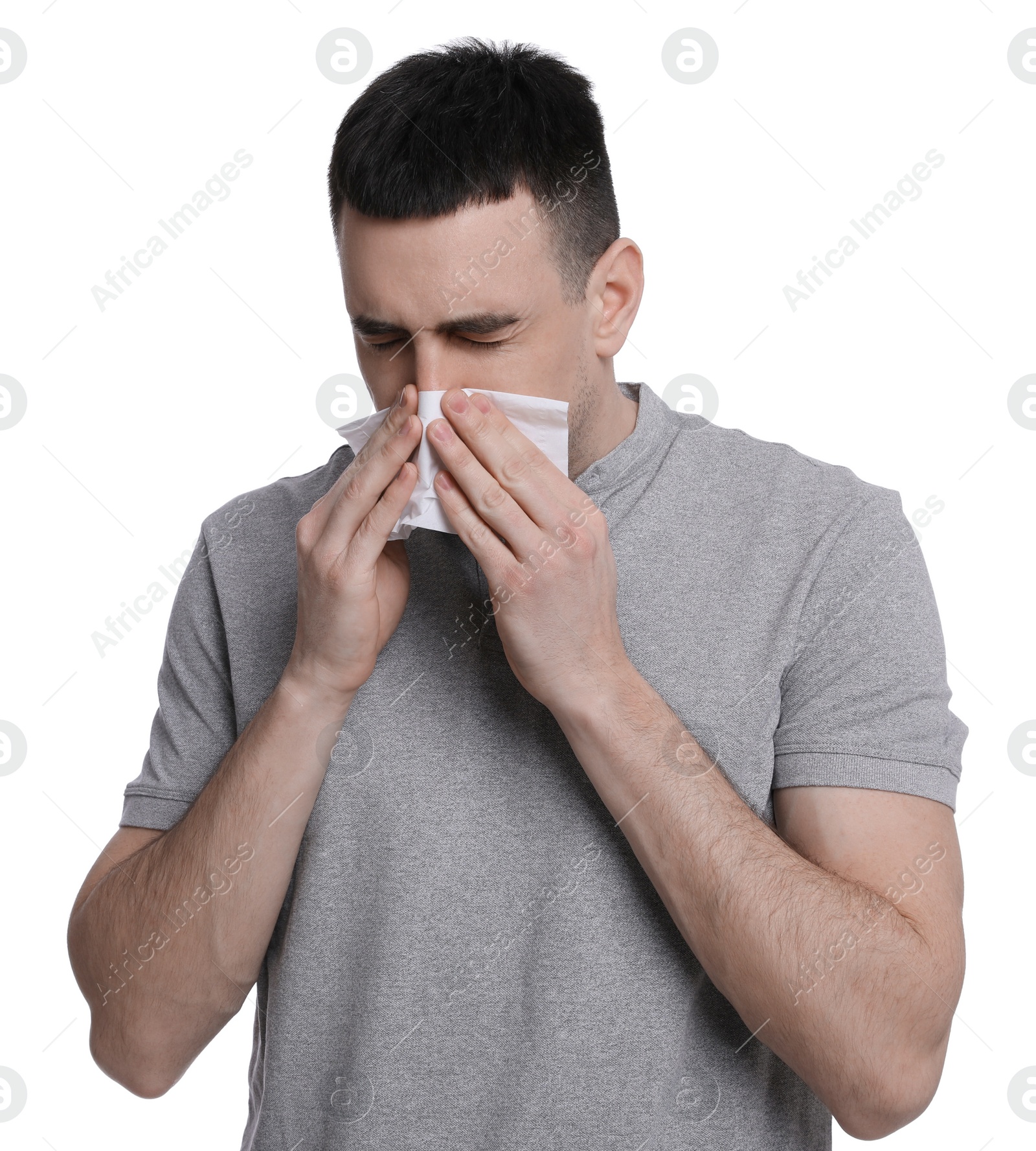 Photo of Man blowing nose in tissue on white background. Cold symptoms