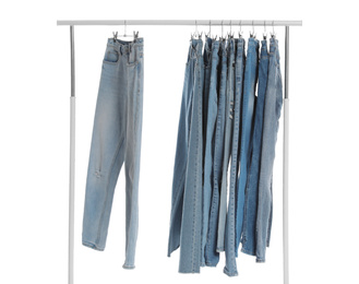 Photo of Rack with different jeans isolated on white