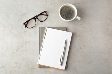 Photo of Flat lay composition with office stationery and cup of coffee on light stone background