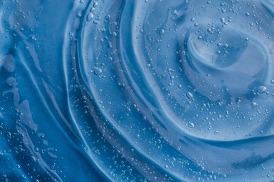 Photo of Texture of light blue shower gel as background, top view