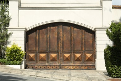 Beautiful old metal gate and white wall outdoors