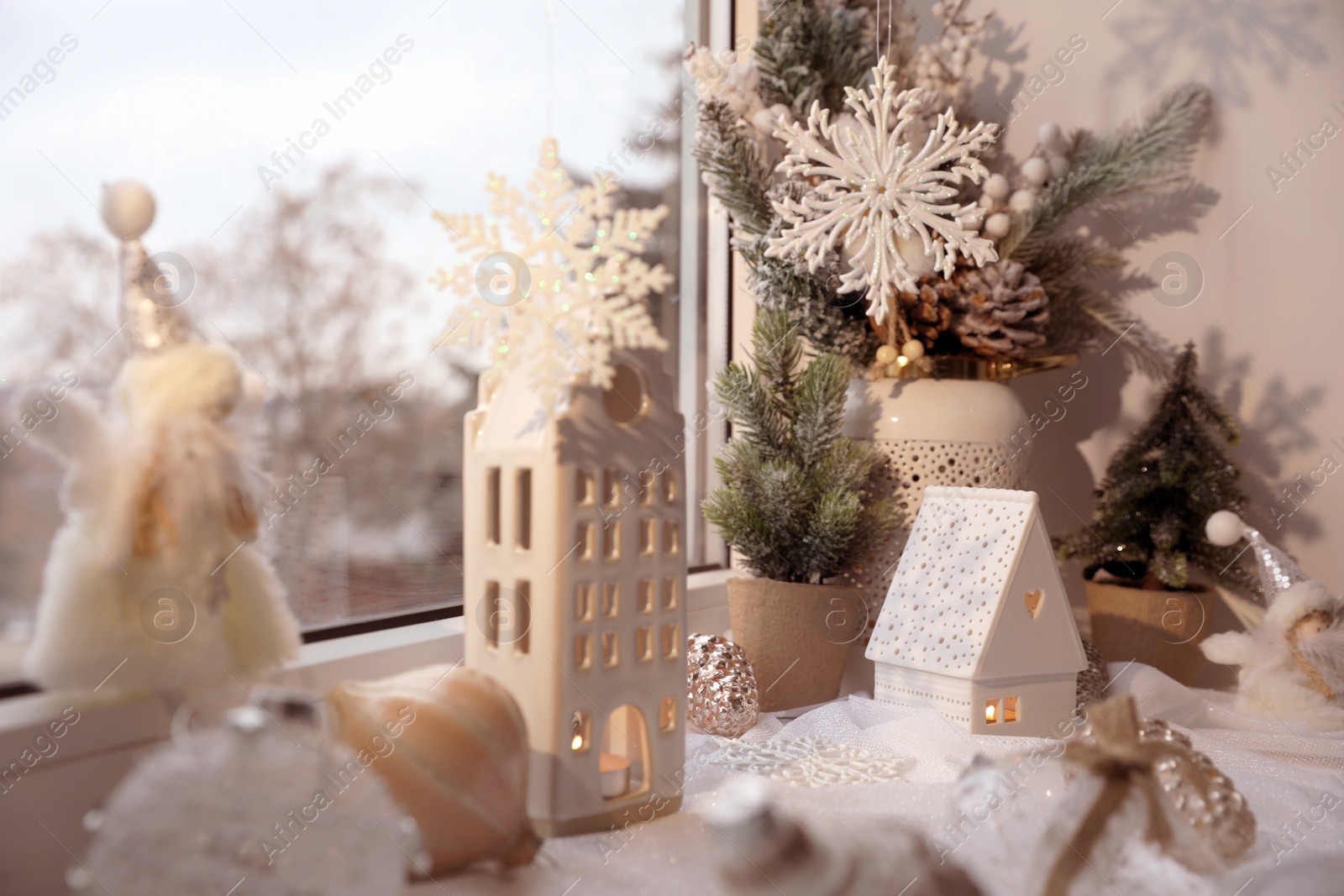 Photo of Many beautiful Christmas decorations and fir branches on window sill indoors