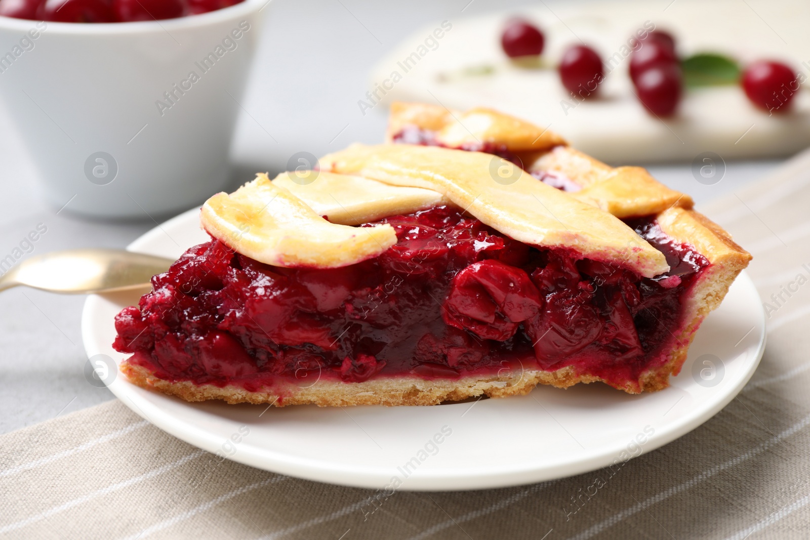 Photo of Slice of delicious fresh cherry pie on table, closeup