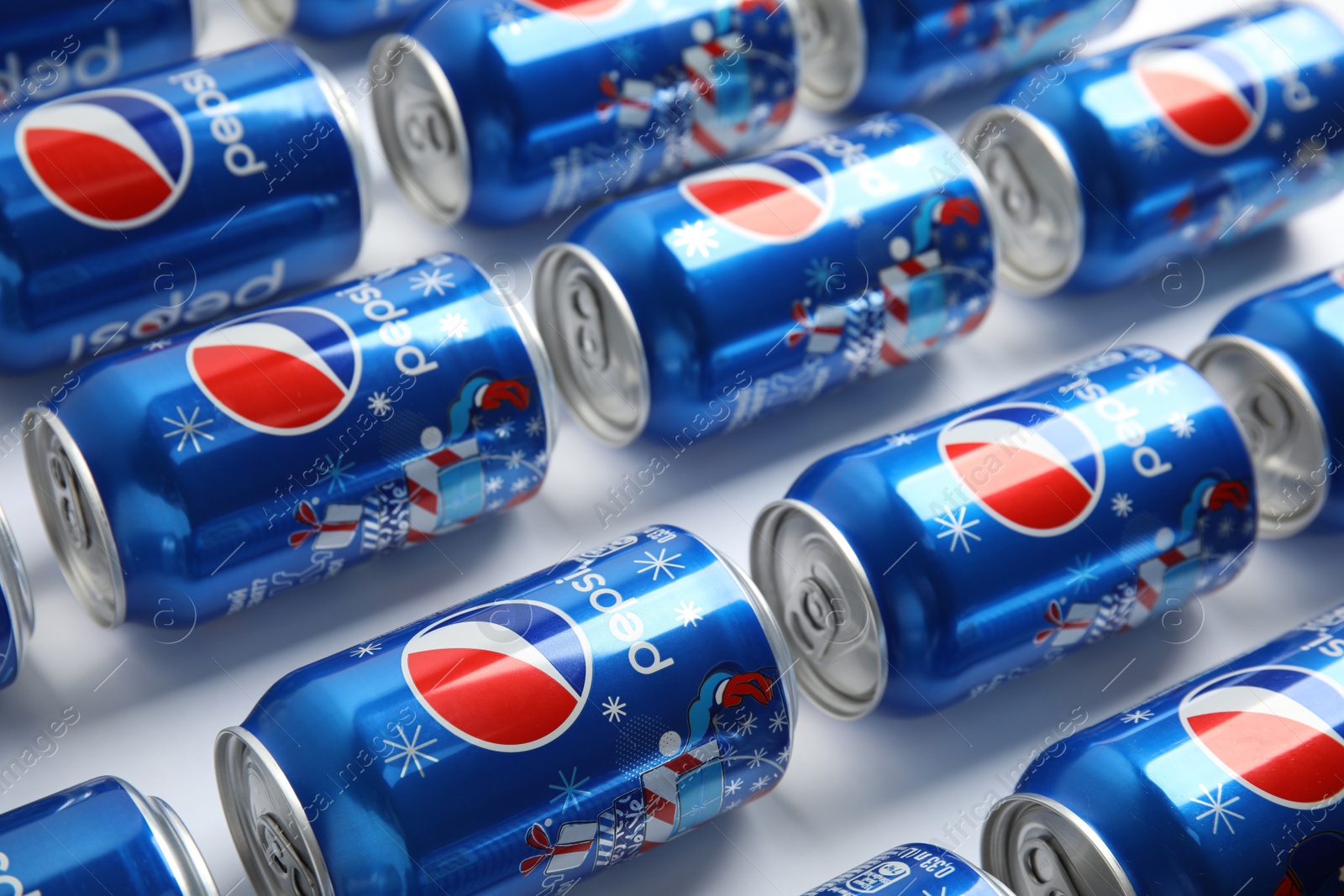 Photo of MYKOLAIV, UKRAINE - FEBRUARY 08, 2021: Cans of Pepsi on white background, closeup