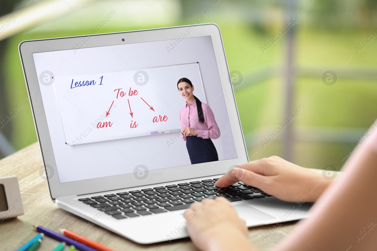 Image of Woman using laptop for online English learning with teacher indoors, closeup