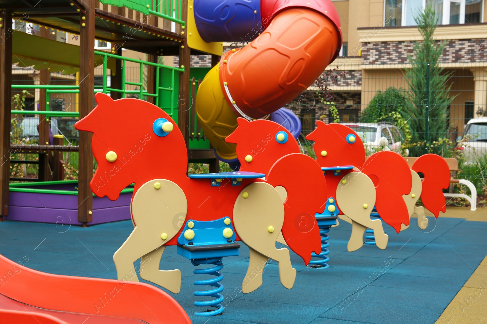 Photo of Colourful spring horse on outdoor playground in residential area