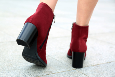 Photo of Woman wearing comfortable stylish boots outdoors, closeup