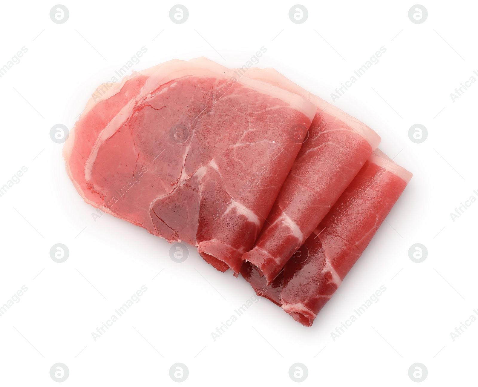 Photo of Slices of delicious jamon on white background, top view