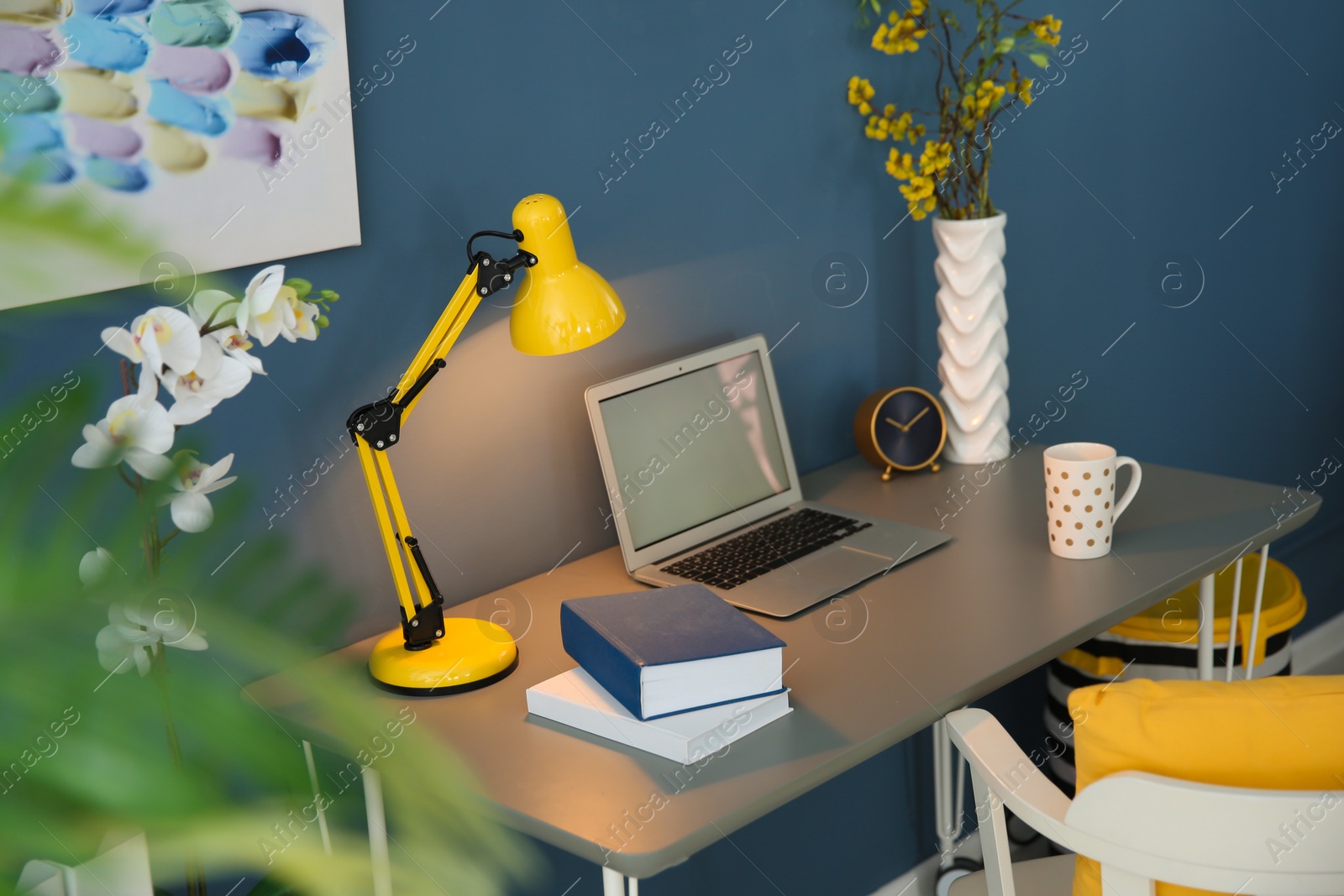 Photo of Comfortable workplace with laptop on desk in home office