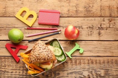 Composition with lunch box on wooden background