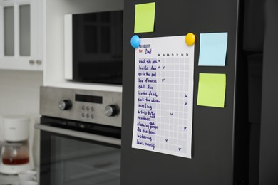 Photo of To do list and sticky notes on fridge in kitchen. Space for text