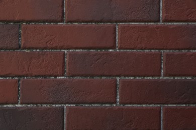 Photo of Texture of dark red brick wall as background