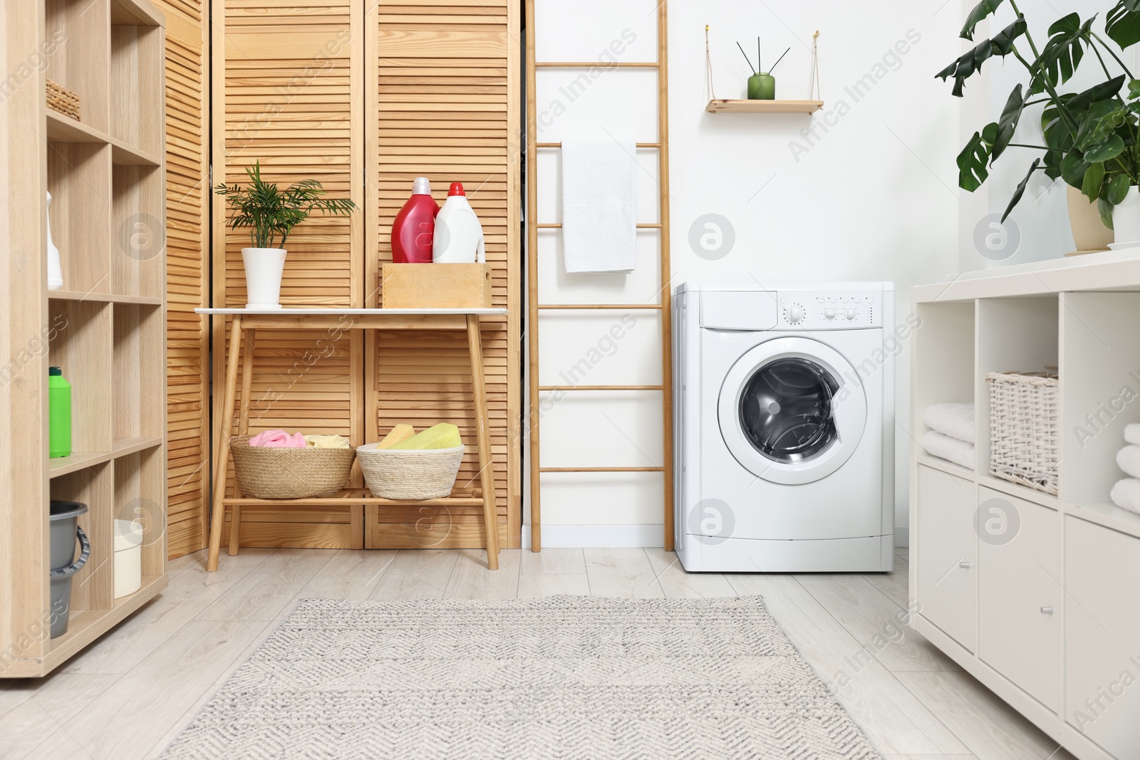 Photo of Laundry room interior with washing machine and furniture