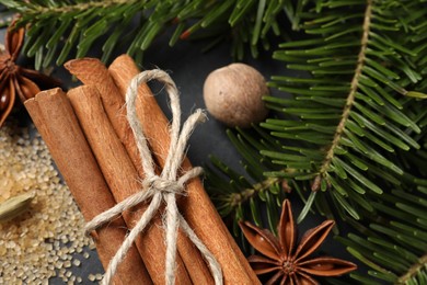 Photo of Different spices, nut and fir branches on table, flat lay