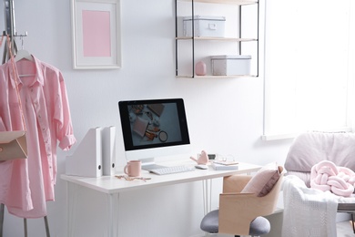 Photo of Comfortable workplace with computer on desk in home office