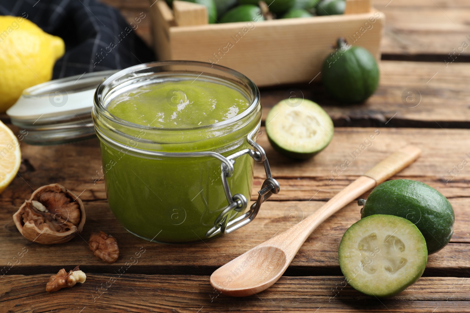 Photo of Feijoa jam in glass jar on wooden table