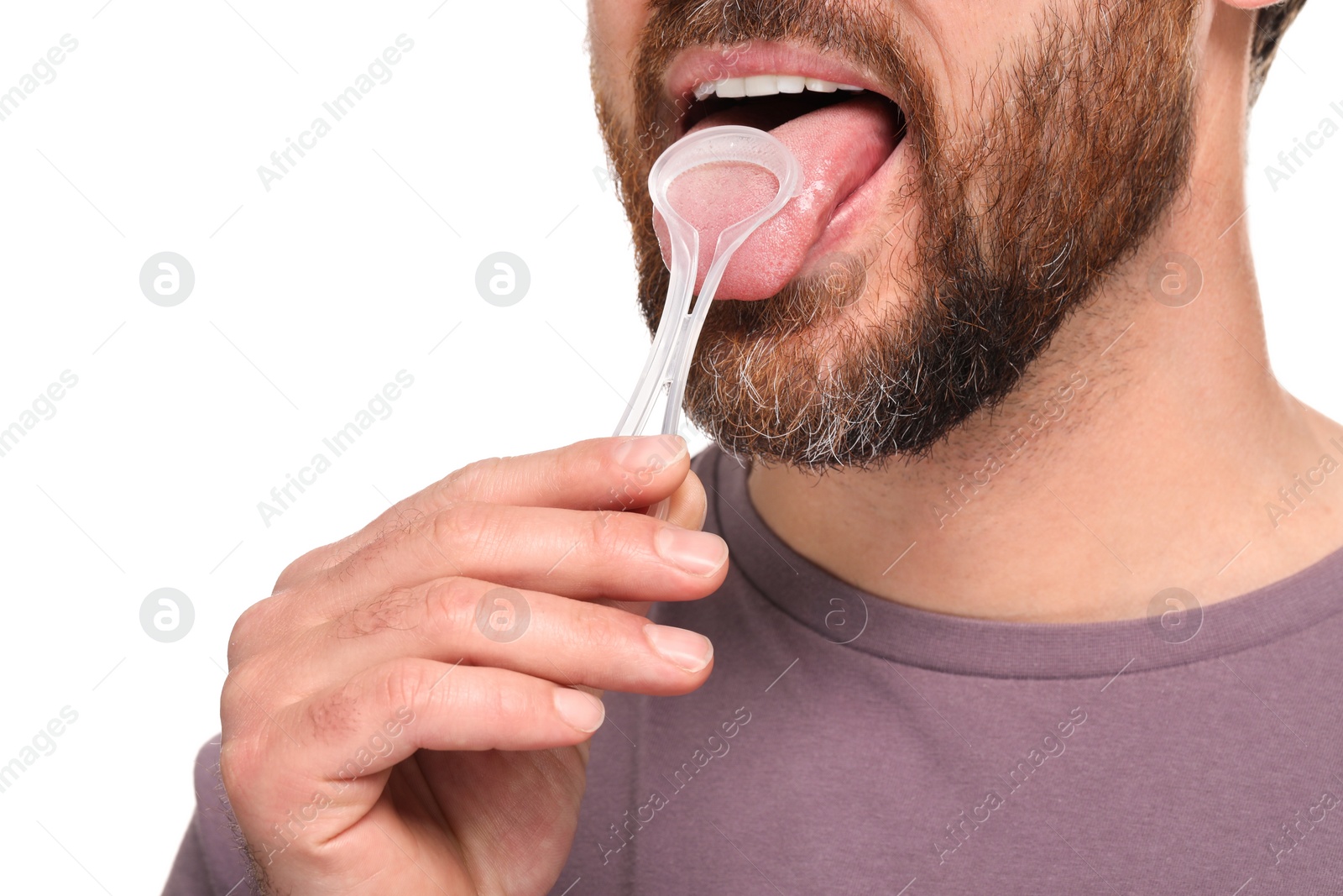 Photo of Man brushing his tongue with cleaner on white background, closeup