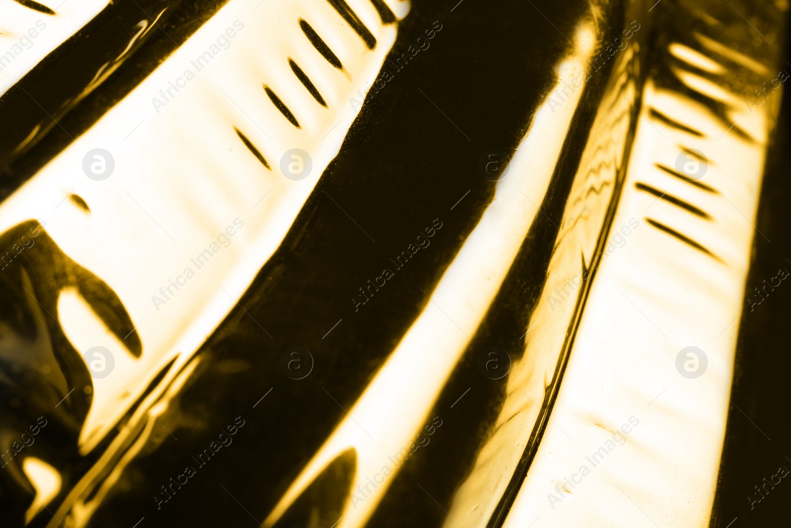 Photo of Closeup view of shiny golden surface as background