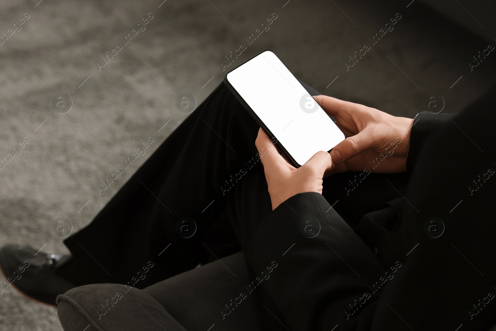 Photo of Man using smartphone with blank screen indoors, closeup. Mockup for design