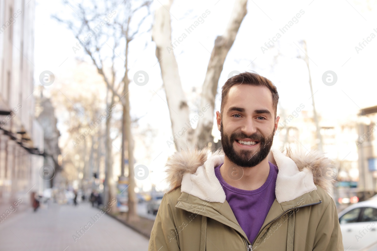 Photo of Portrait of handsome young man on city street