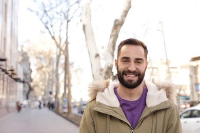 Portrait of handsome young man on city street