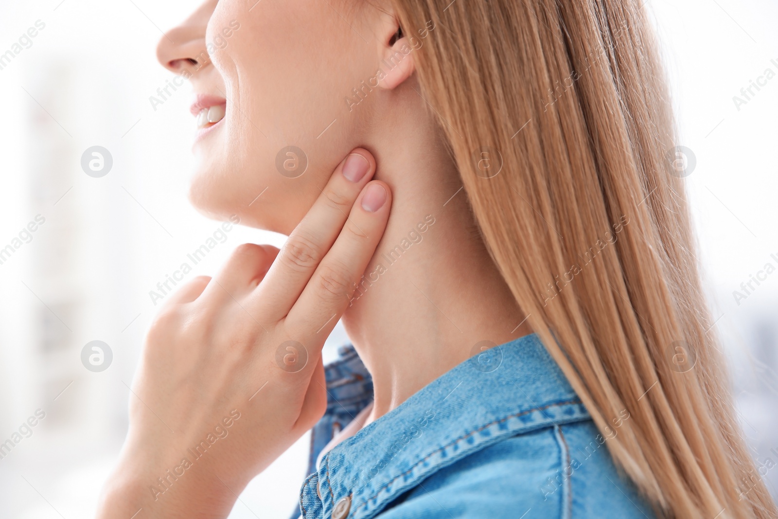 Photo of Young woman checking pulse on blurred background