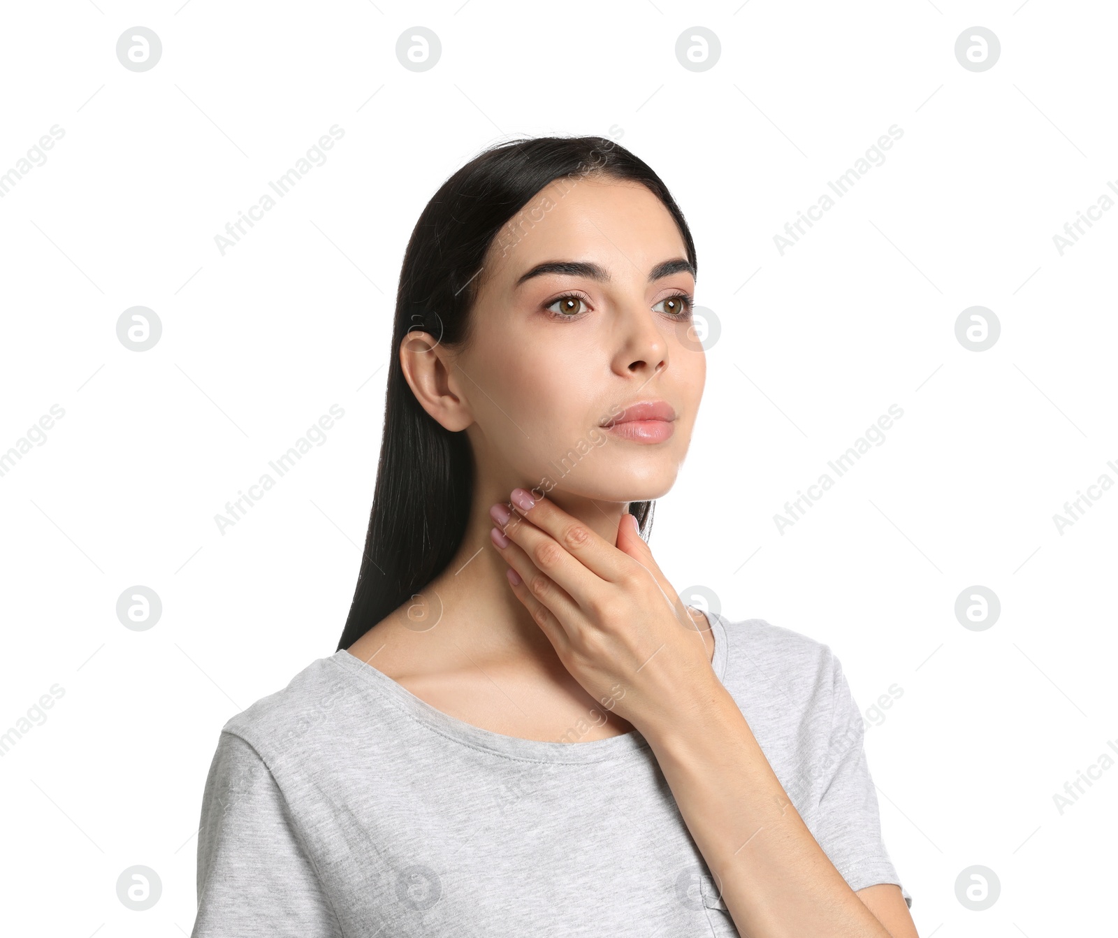 Photo of Young woman doing thyroid self examination on white background