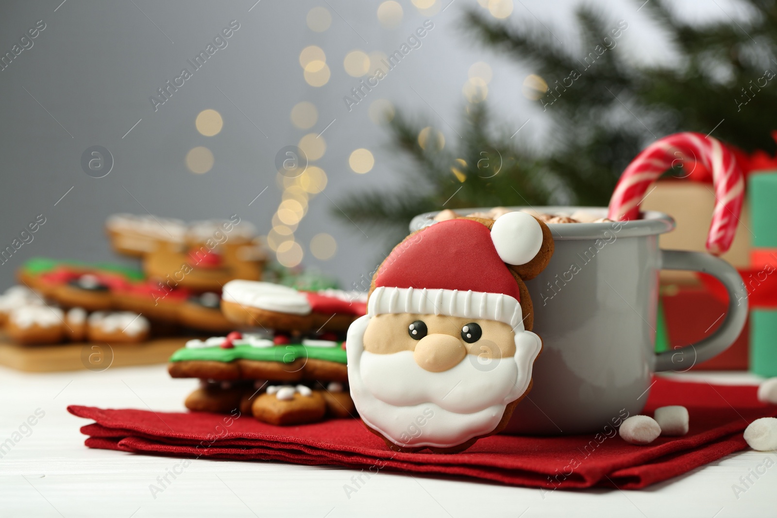 Photo of Tasty homemade Christmas cookie and hot drink with marshmallows on white table