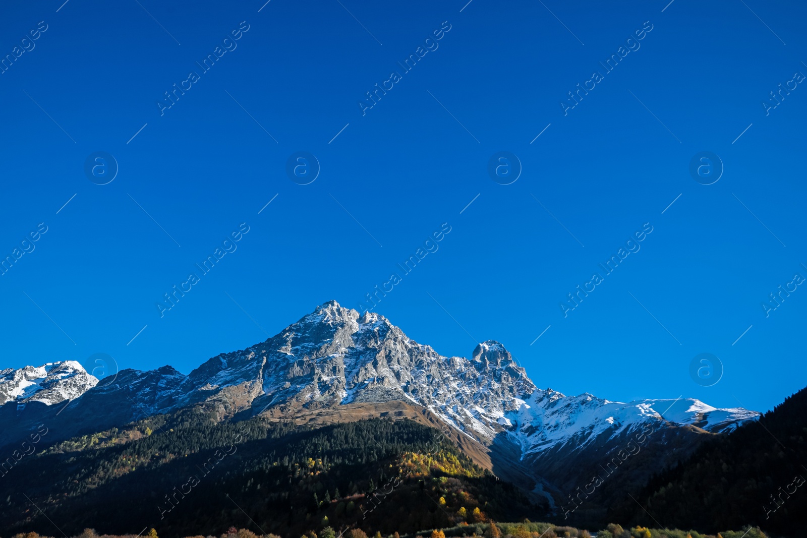 Photo of Picturesque view of beautiful high mountain under blue sky on sunny day