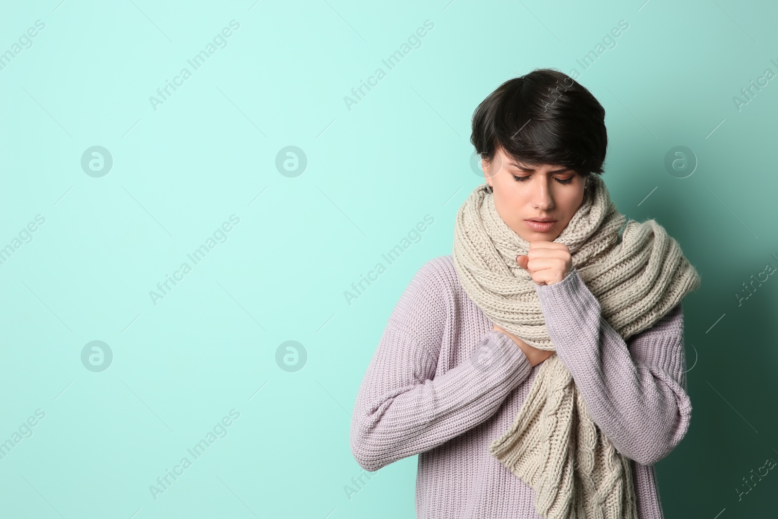 Photo of Young woman coughing on color background