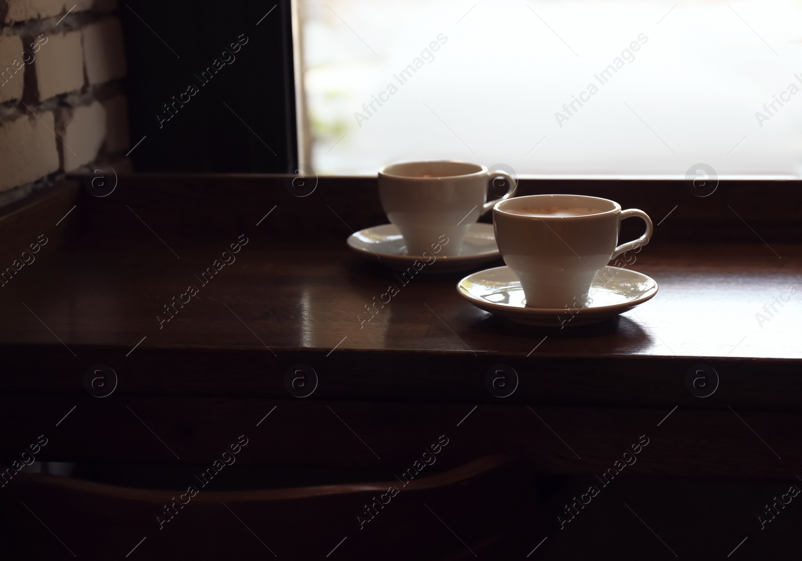 Photo of Cups of fresh aromatic coffee on table