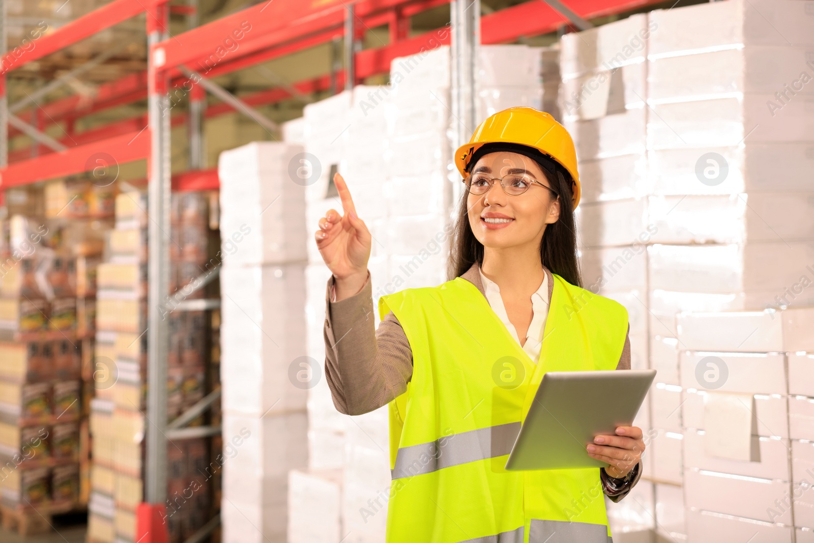 Image of Woman with tablet working at warehouse. Logistics center