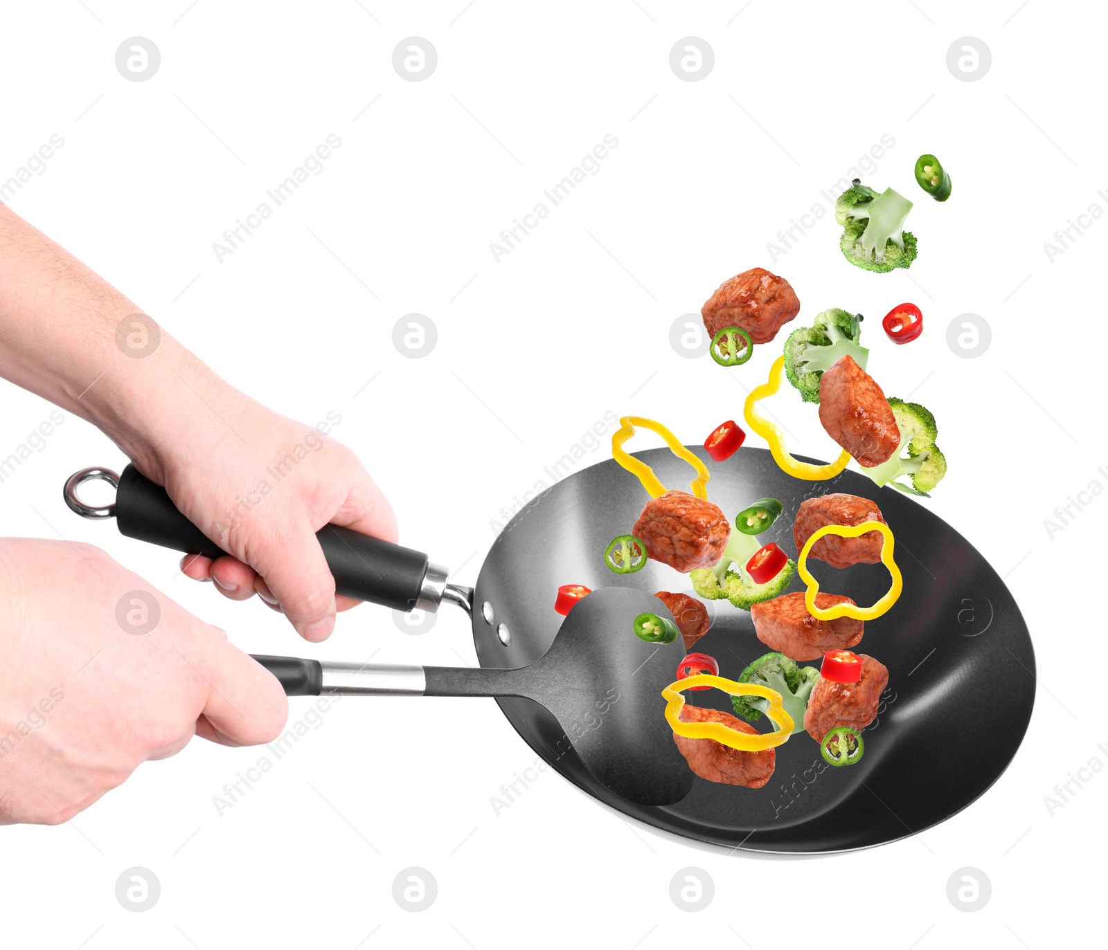 Image of Man tossing ingredients in wok on white background, closeup