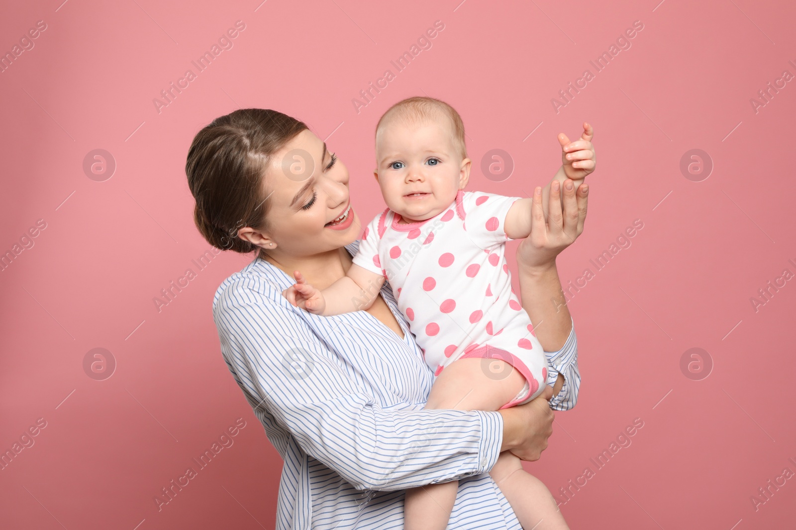 Photo of Portrait of happy mother with her baby on color background