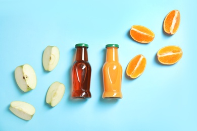 Photo of Flat lay composition with different drinks in bottles and ingredients on color background