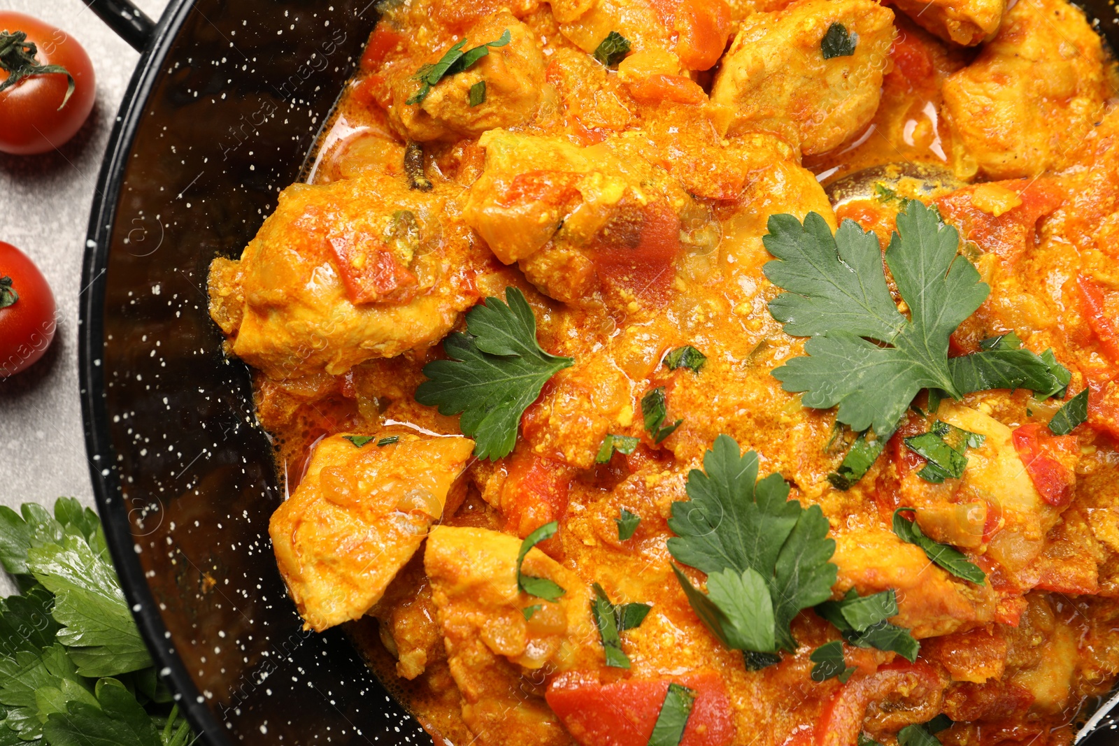 Photo of Delicious chicken curry in frying pan on table, top view