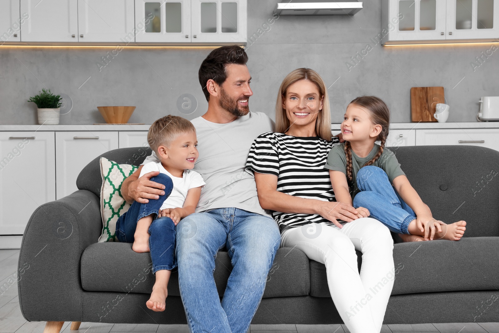 Photo of Portrait of happy family with children on sofa at home