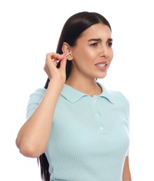 Photo of Young woman cleaning ear with cotton swab on white background