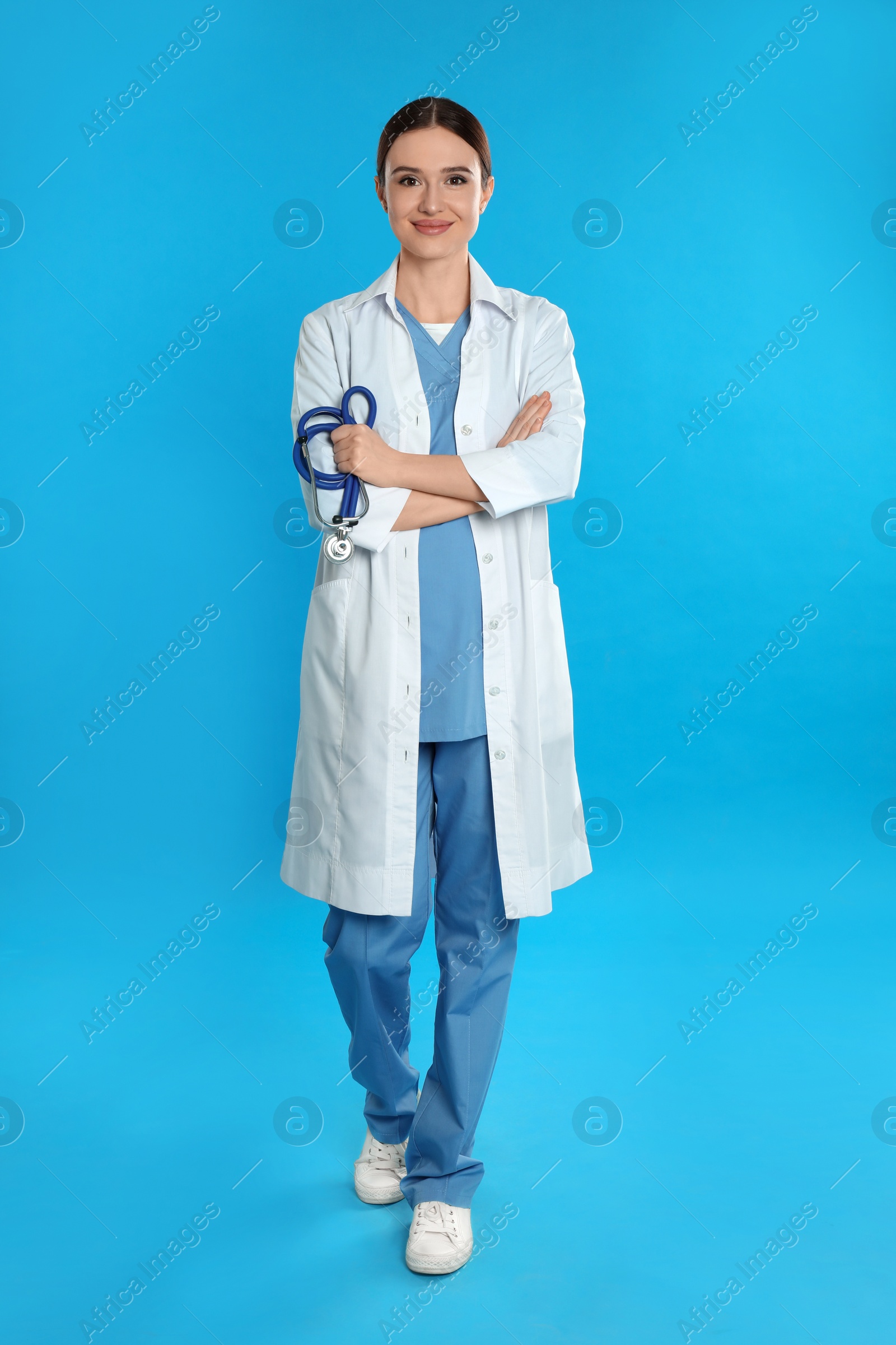 Photo of Portrait of doctor with stethoscope on blue background