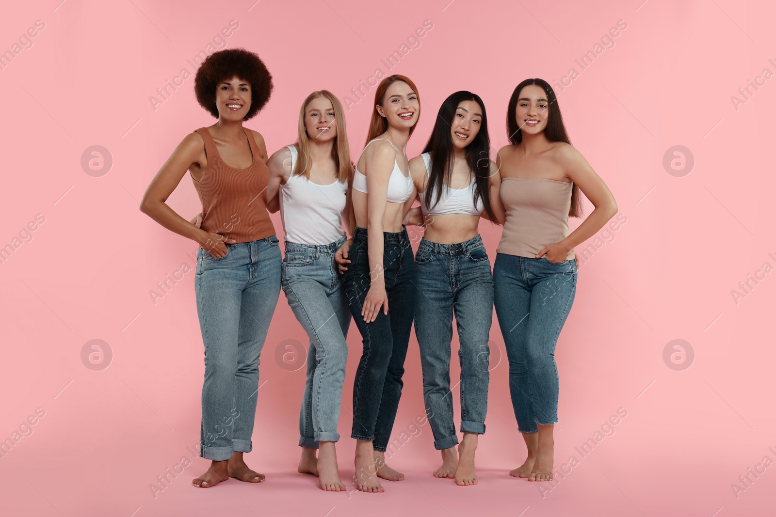 Photo of Group of beautiful young women on pink background